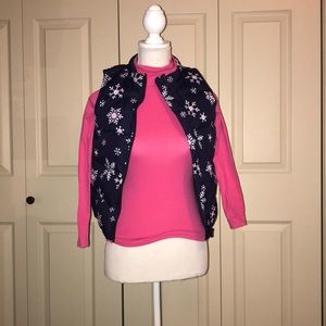 Blue sweater vest with pink turtleneck.